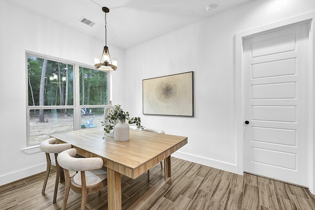 dining space featuring a wealth of natural light and a notable chandelier