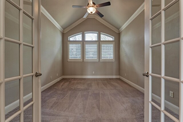 carpeted empty room featuring crown molding, vaulted ceiling, french doors, and ceiling fan