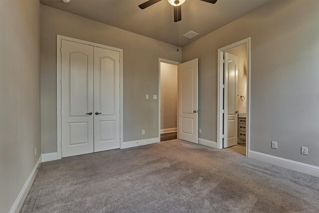 unfurnished bedroom with ensuite bathroom, light colored carpet, ceiling fan, and a closet