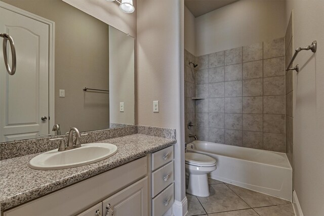 full bathroom with vanity, toilet, tiled shower / bath combo, and tile patterned flooring