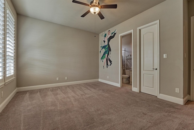 spare room with carpet, a ceiling fan, and baseboards