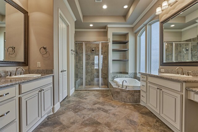 bathroom featuring a raised ceiling, vanity, shower with separate bathtub, and crown molding