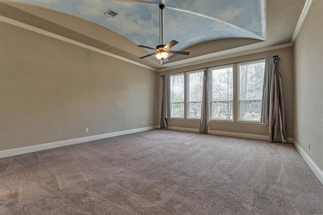 unfurnished room featuring light carpet, ornamental molding, a raised ceiling, and ceiling fan