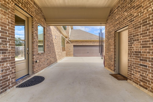 view of patio / terrace featuring a garage and concrete driveway