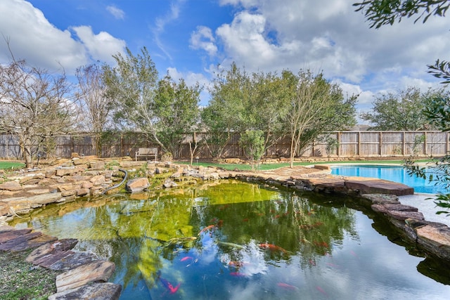 view of swimming pool with a fenced in pool and a fenced backyard