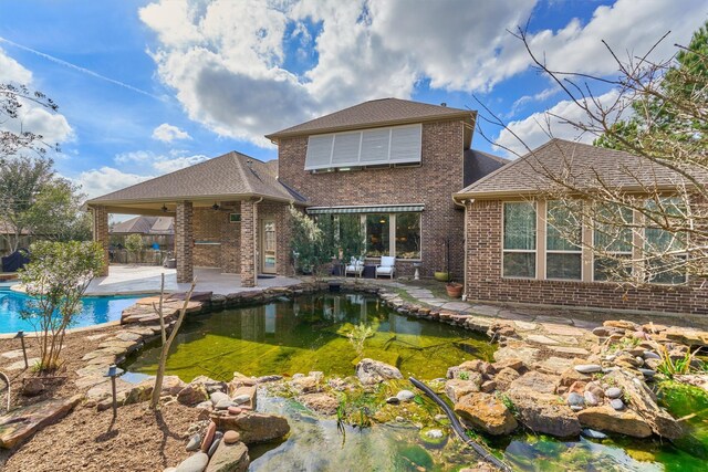 back of property with a patio and ceiling fan