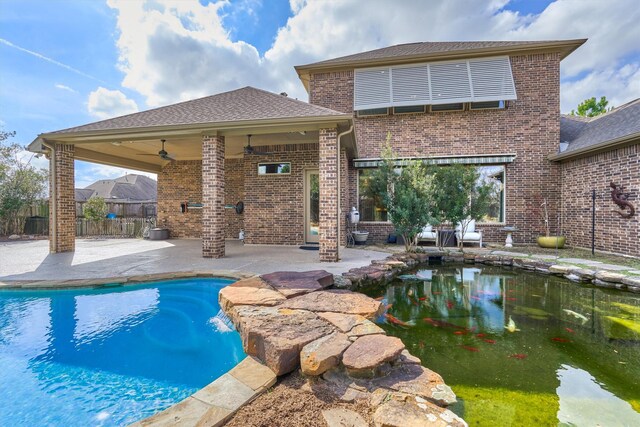 view of swimming pool with ceiling fan and a patio