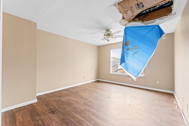 spare room with wood-type flooring, a textured ceiling, and ceiling fan