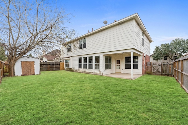 rear view of house featuring a lawn, a patio area, and a storage unit