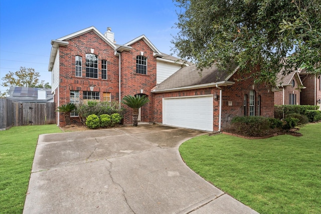 front facade featuring a front yard and a garage