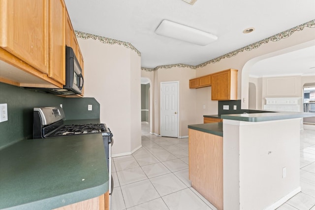 kitchen with light tile patterned flooring and stainless steel range with gas stovetop