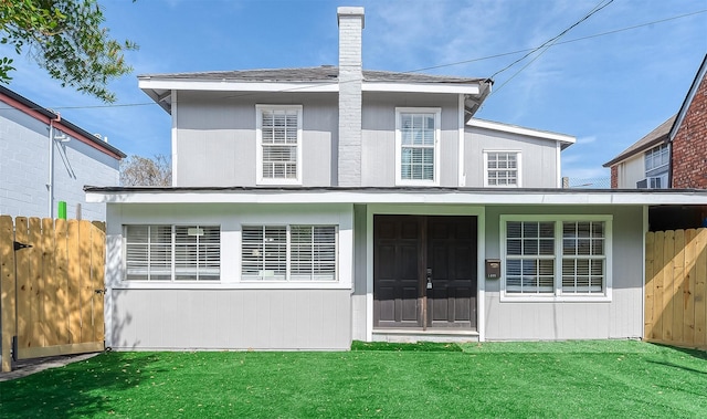 back of property featuring a lawn