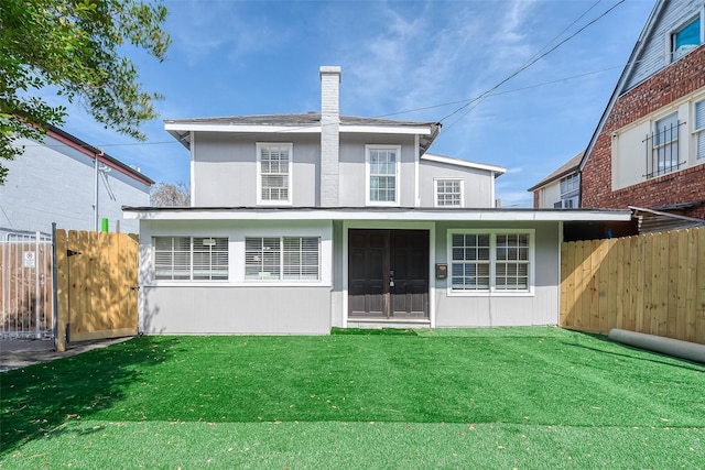 back of house featuring a yard