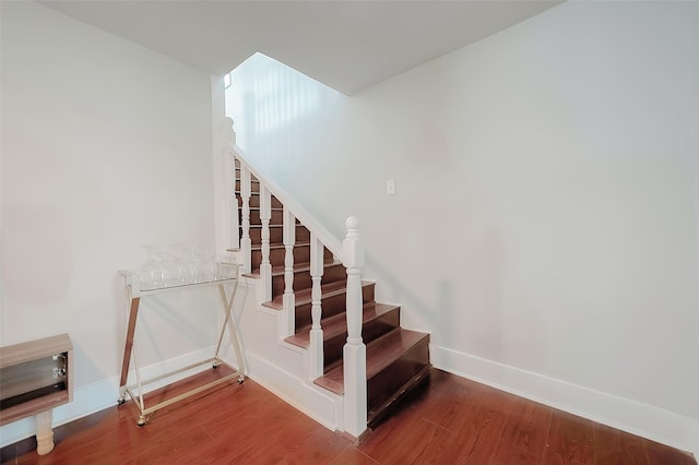 stairs featuring hardwood / wood-style flooring