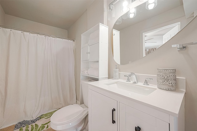 bathroom featuring vanity, toilet, and walk in shower