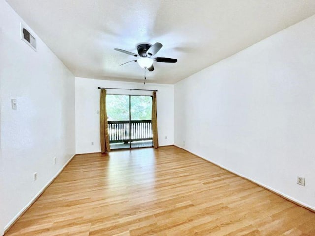 empty room featuring ceiling fan and light hardwood / wood-style floors