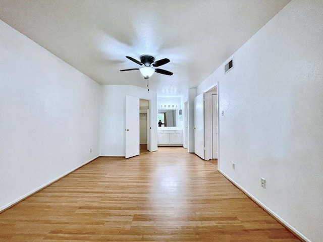 spare room with light wood-type flooring and ceiling fan