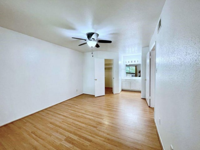 interior space featuring ceiling fan, light hardwood / wood-style floors, and a closet