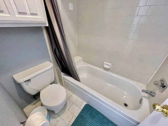 bathroom with tile patterned flooring, shower / bath combination with curtain, and toilet