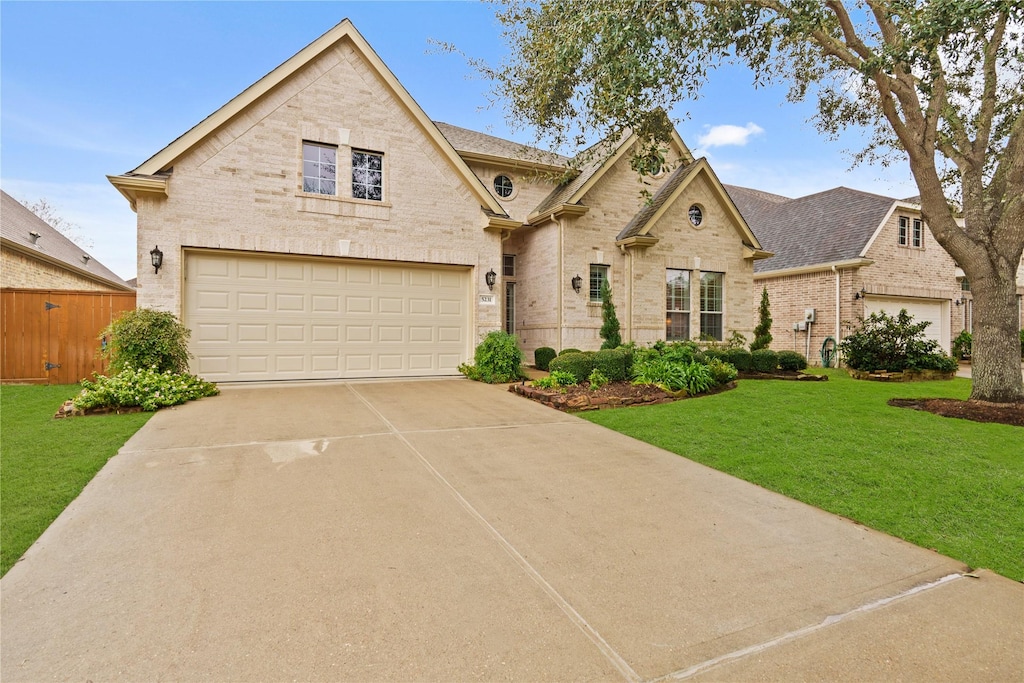 view of front of house with a front lawn and a garage