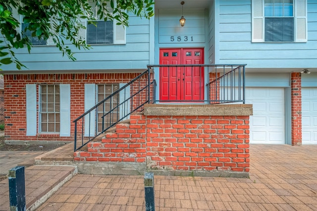 view of exterior entry with a garage