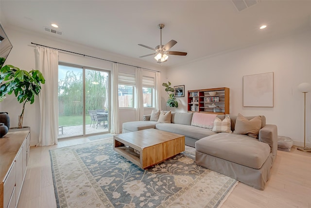 living room with ceiling fan and light wood-type flooring