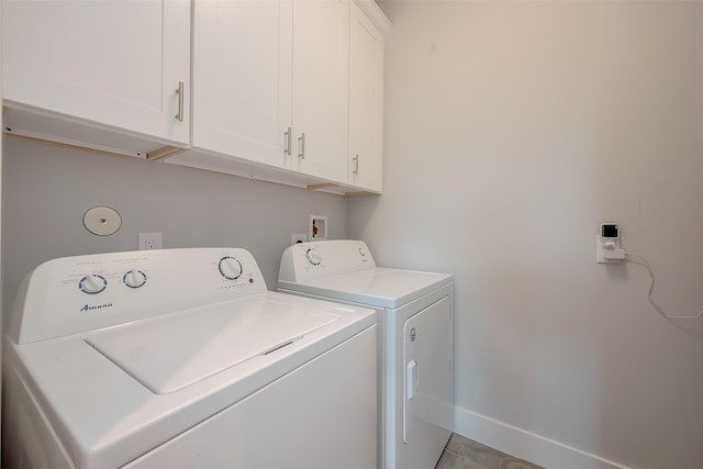 laundry area featuring cabinets and separate washer and dryer