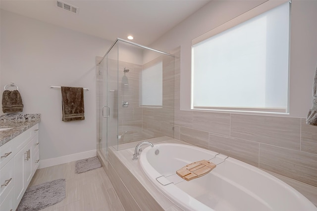 bathroom featuring vanity and shower with separate bathtub