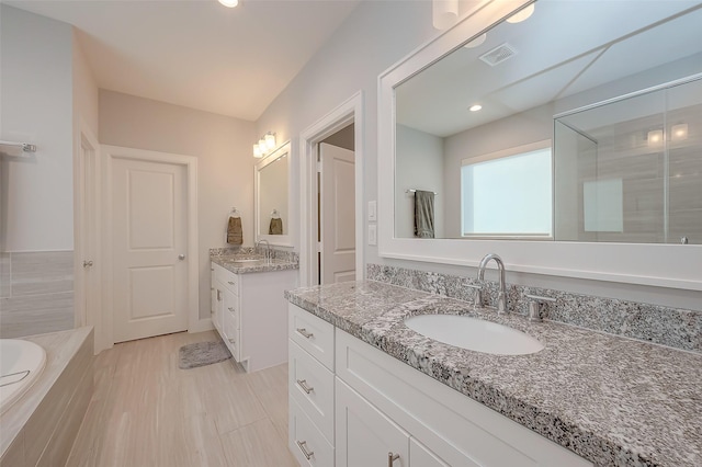 bathroom with vanity, a shower with door, and wood-type flooring