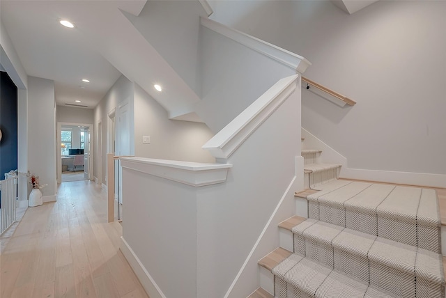 staircase with hardwood / wood-style floors