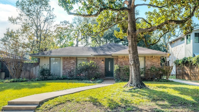 ranch-style home featuring a front yard