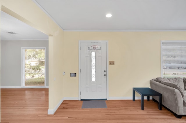 entryway featuring light hardwood / wood-style floors and ornamental molding