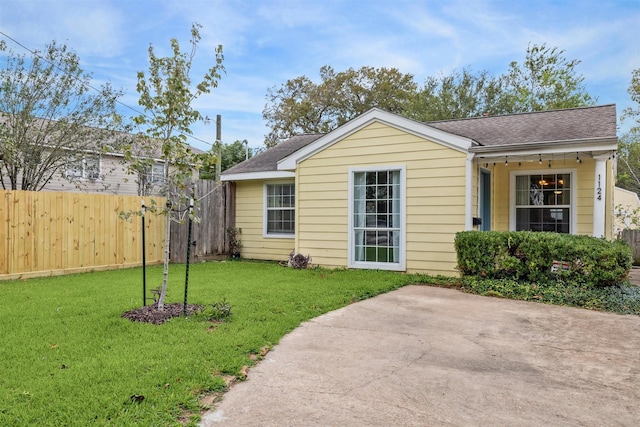 back of property featuring a lawn