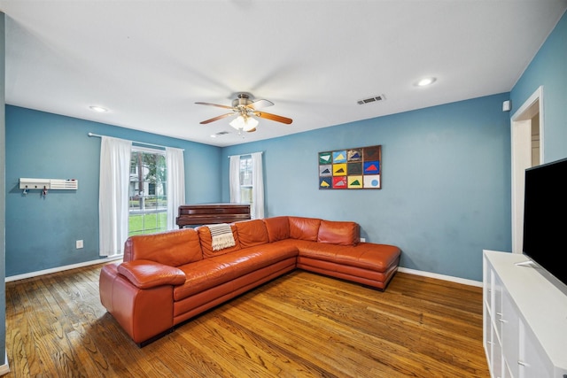 living room with ceiling fan and dark wood-type flooring