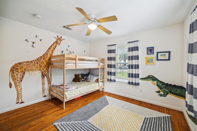 bedroom with ceiling fan and wood-type flooring