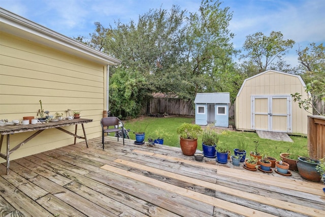 wooden deck featuring a lawn and a storage unit