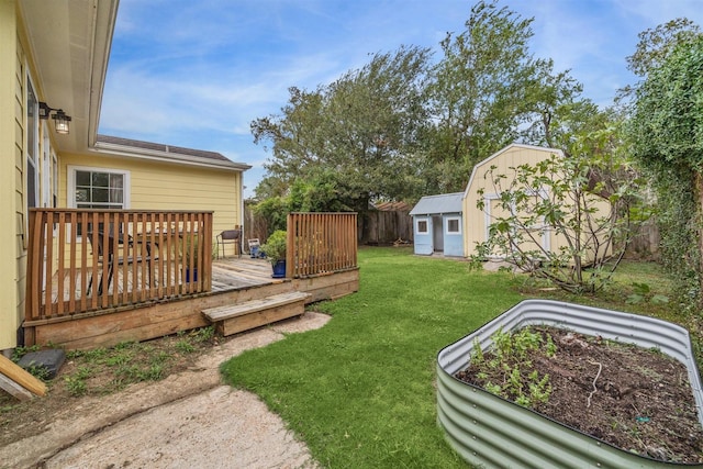 view of yard featuring a deck and a storage shed