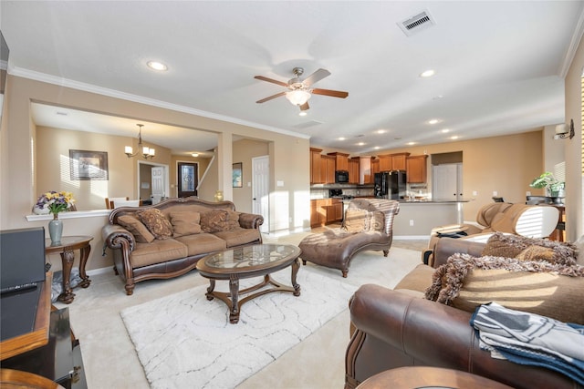 carpeted living room featuring ceiling fan with notable chandelier and ornamental molding