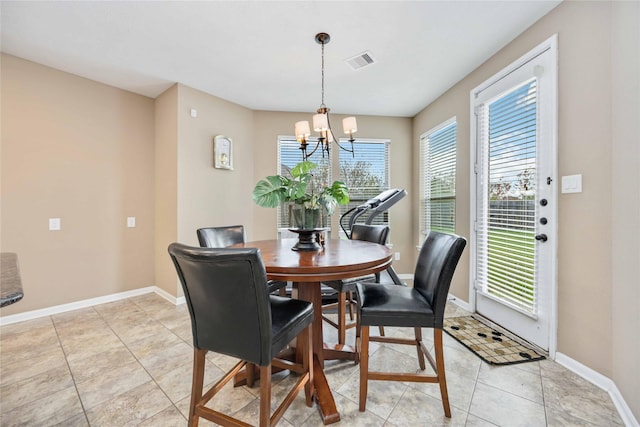 dining space with light tile patterned floors and a chandelier