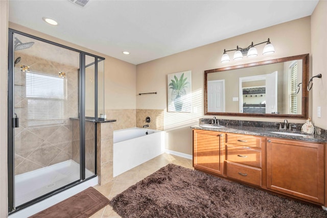 bathroom featuring tile patterned flooring, vanity, separate shower and tub, and a healthy amount of sunlight