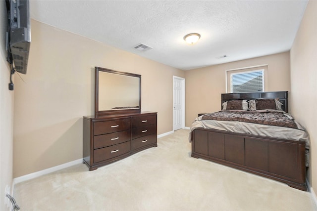 carpeted bedroom with a textured ceiling