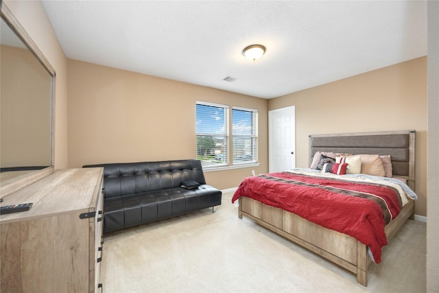 bedroom featuring light colored carpet