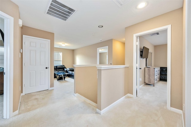 corridor featuring light colored carpet