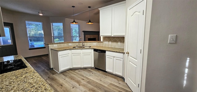 kitchen with dishwasher, sink, kitchen peninsula, decorative backsplash, and white cabinets