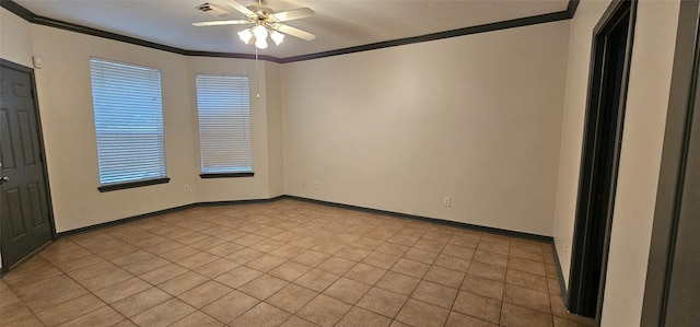 tiled empty room featuring ceiling fan and crown molding