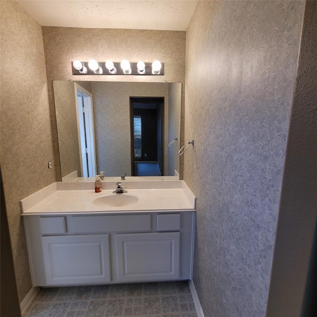 bathroom with a textured ceiling and vanity