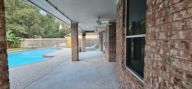 view of pool with ceiling fan and a patio area