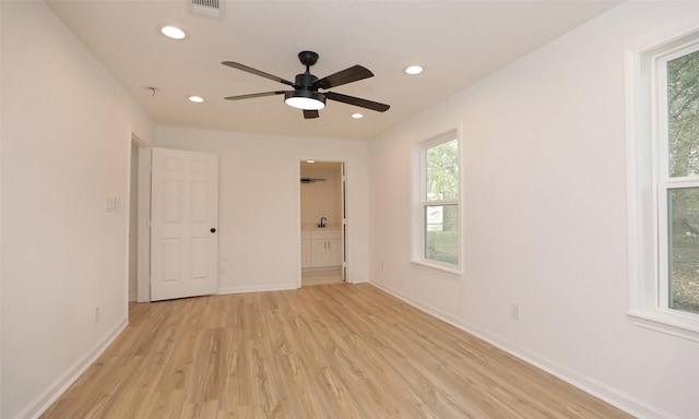 empty room featuring light wood-type flooring and ceiling fan