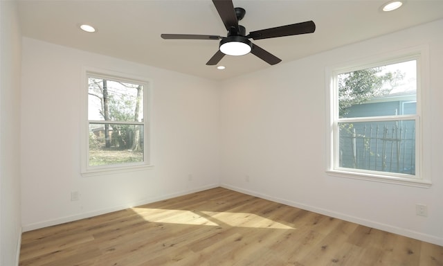 spare room featuring ceiling fan and light hardwood / wood-style flooring