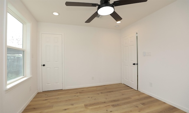 unfurnished room with ceiling fan and light wood-type flooring